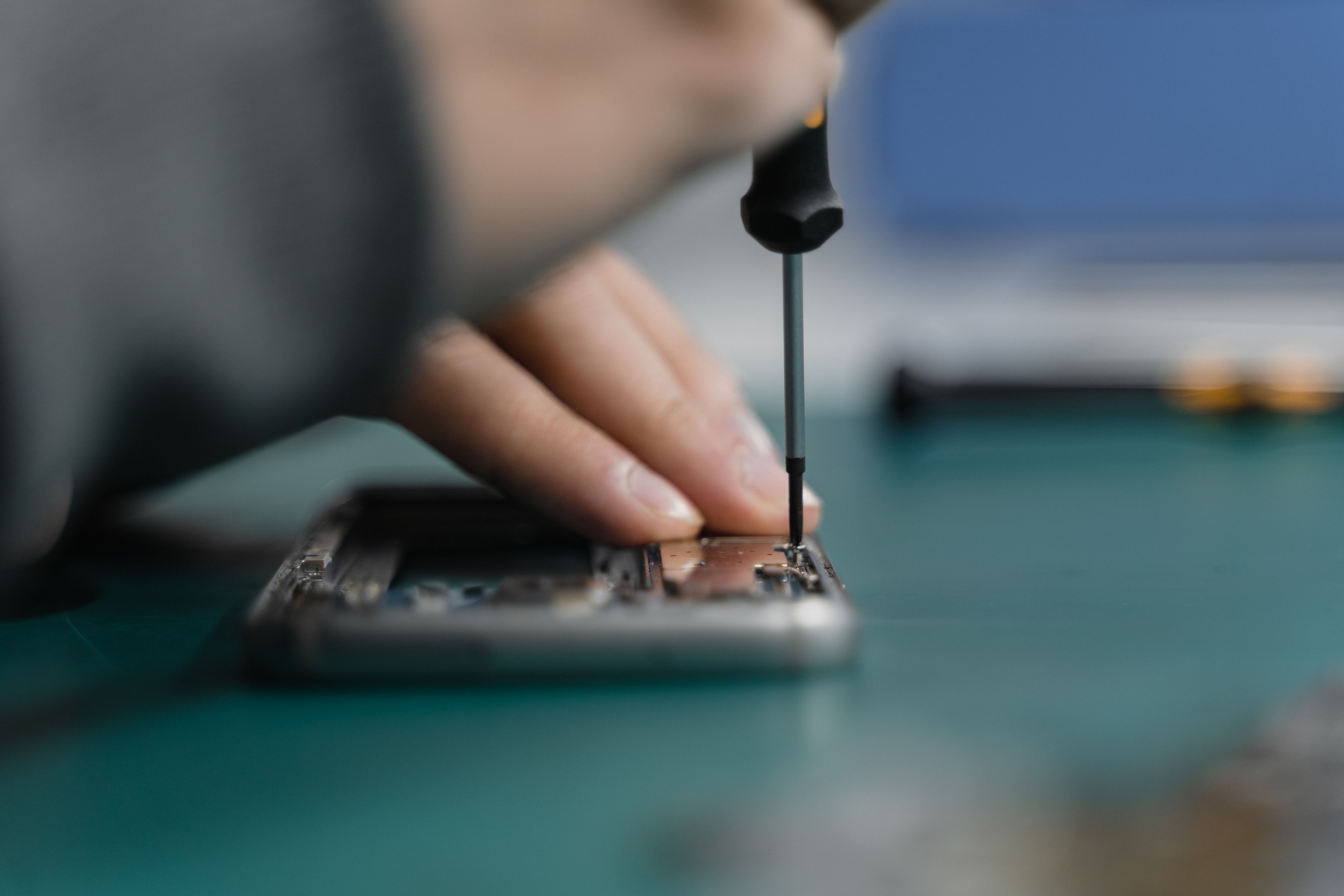 Electronics repair near Dubai - technician repairing PCB and TV