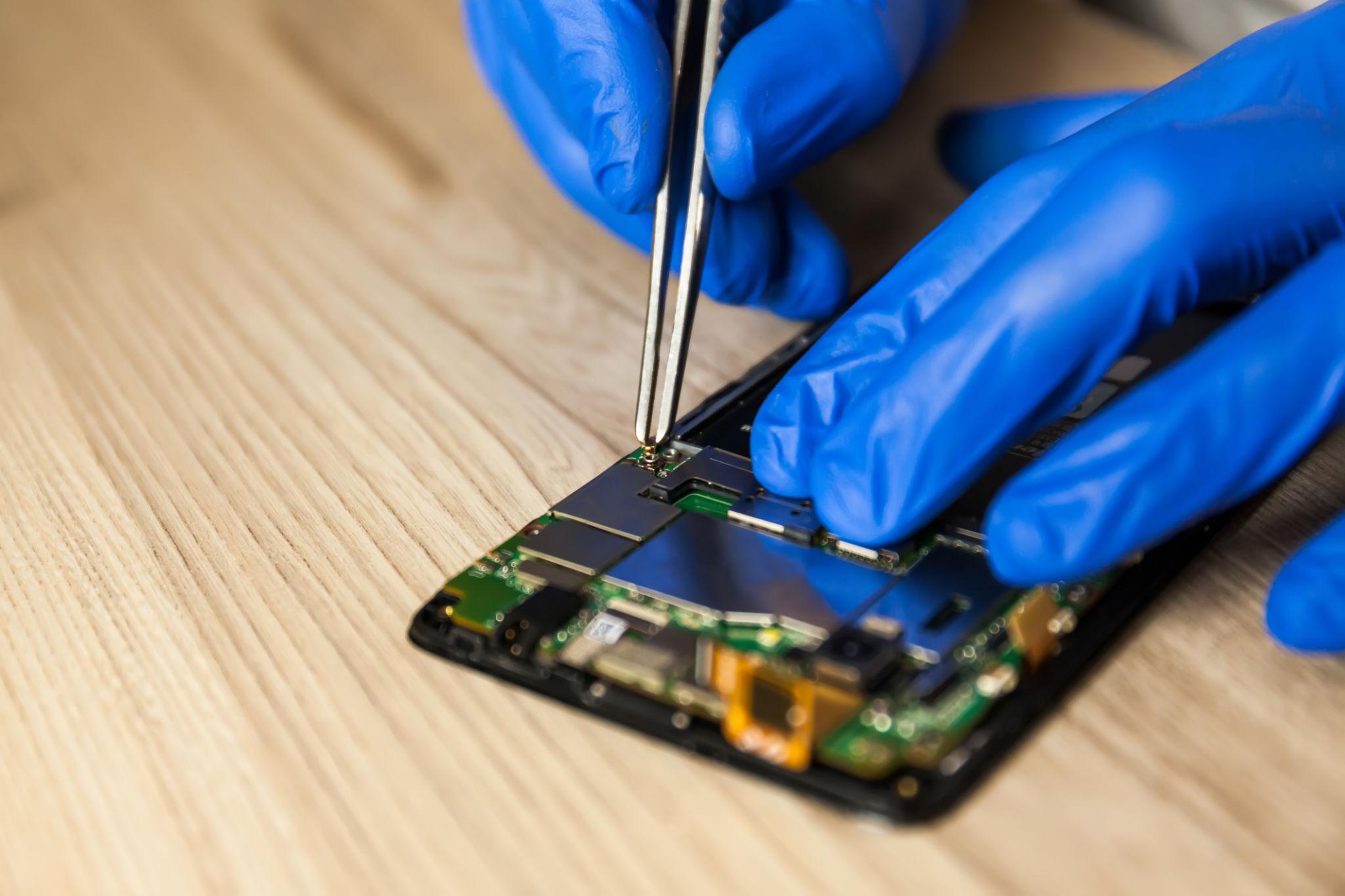 Expert repairing smartphone camera module in Barsha Heights