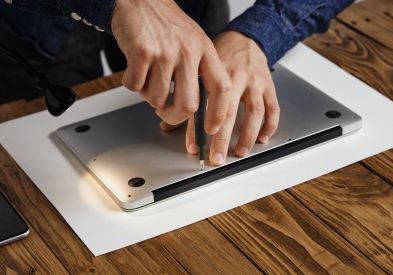 MacBook technician repairing a laptop in Al Barsha Dubai