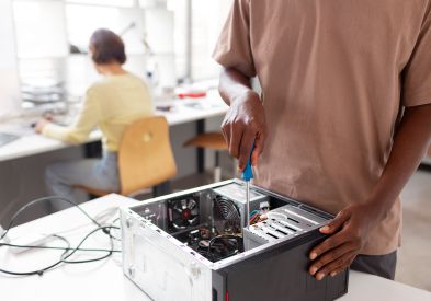 Technician repairing a desktop computer in Al Barsha Dubai
