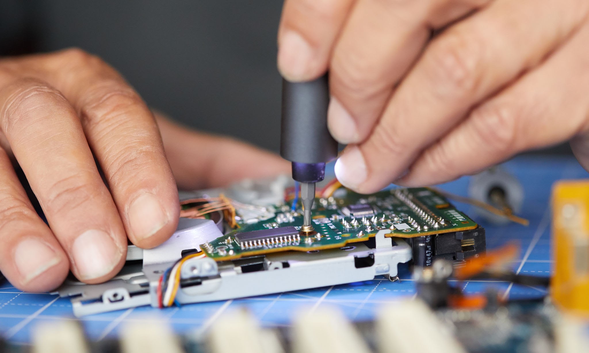 Electronics repair shop in Al Barsha Dubai — Al Barsha Electronics LLC technician repairing a device